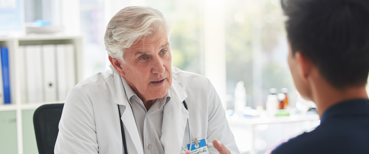 Older Doctor Speaking with Younger Doctor