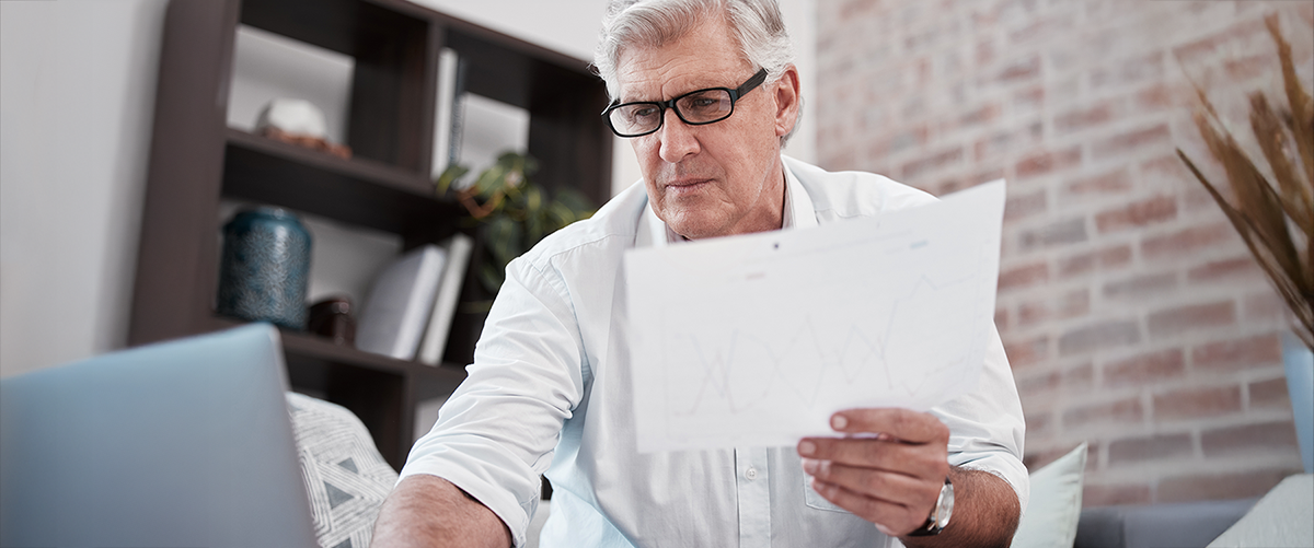 Older Man Looking at Health Insurance Documents